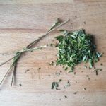 Houten snijplank met fijngehakte rozemarijn